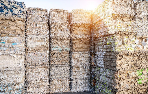 Stacks of recyclables wrapped with baling wire.